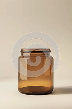 An empty amber glass jar against a neutral backdrop