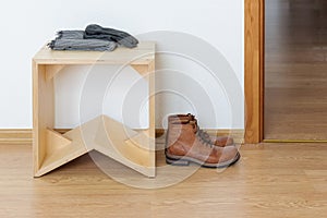 Empty anteroom with wooden stool and leather boots