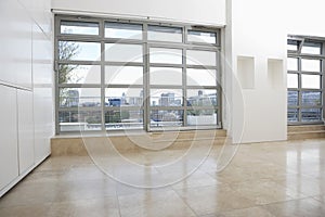 Empty Apartment With Tiled Flooring And Windows