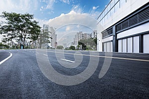 Empty asphalt and city buildings landscape