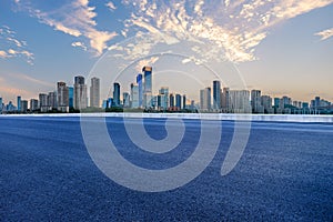 Empty asphalt road and city skyline