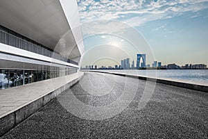 Empty asphalt road and city skyline