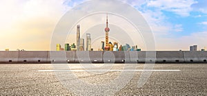 Empty asphalt road and city skyline landscape at sunset in Shanghai