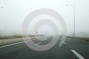 empty asphalt road on a foggy day