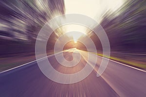 Empty asphalt road in motion blur and sunlight