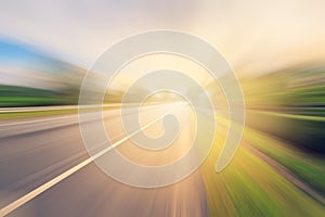 Empty asphalt road in motion blur and sunlight