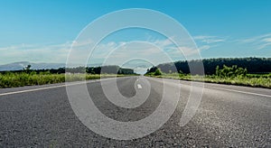 Empty asphalt road and mountain with blue sky scenery background