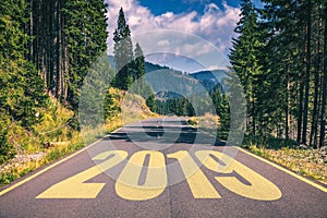 Empty asphalt road and New year 2019 concept. Driving on an empty road in the mountains to upcoming 2019 and leaving behind old 2