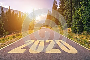 Empty asphalt road and New year 2020 concept. Driving on an empty road in the mountains to upcoming 2020 and leaving behind old