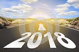 Empty asphalt road and New year 2018 goals concept -