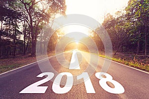 Empty asphalt road and New year 2018 goals concept.