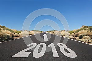 Empty asphalt road and New year 2018 goals concept -