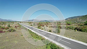 Empty Asphalt Road on the Plateau Between Green Fields, Highland Way Aerial View