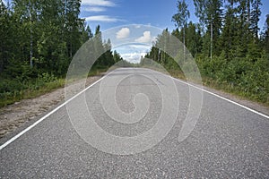 Empty asphalt road in rural landscape, Finland