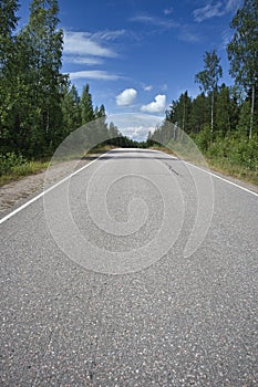 Empty asphalt road in rural landscape, Finland