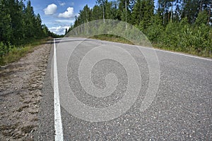 Empty asphalt road in rural landscape, Finland