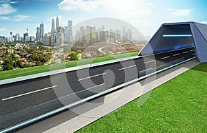 Empty asphalt road with tunnel ,greenfield and modern city skyline