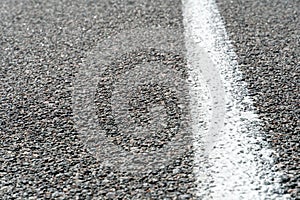 Empty asphalt road. New fresh asphalt pavement away from the city. Development of rural infrastructure. Road marking lines close