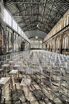 Empty audience seats arranged in raws in rustic industrial plant