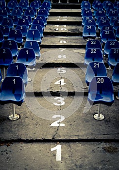 Empty auditorium with blue numbered chairs