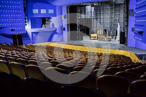 Empty auditorium and stage in the theater. Rehearsal of the play. Artists on stage