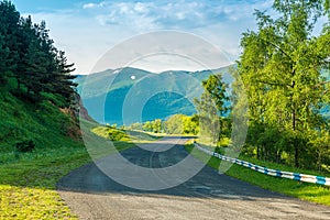 Empty automobile mountain road on a sunny summer day in the picturesque mountains of Transcaucasia photo