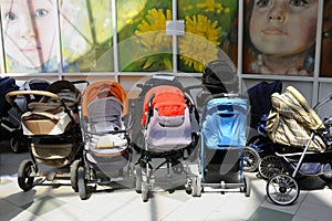 Empty baby buggies left near kid's playroom of the supermarket