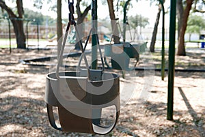 Empty baby / toddler swings in a playground