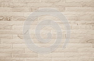 Empty background of wide cream brick wall texture. Beige old brown brick wall concrete or stone textured, wallpaper limestone