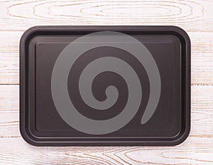 Empty baking tray for pizza on wooden table isolated close up top view square. Mock up for design