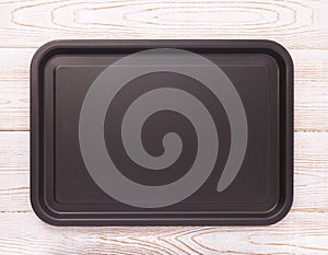 Empty baking tray for pizza on wooden table isolated close up top view square. Mock up for design photo