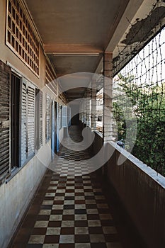 Empty barbed corridor in S21 Tuol Sleng Genocide Museum Phnom Penh Cambodia