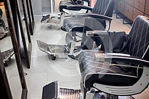 Empty barbershop, hairdresser`s interior, comfortable chairs and modern design, free and clean workplace