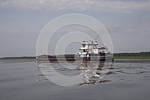 The empty barge floating on the river.