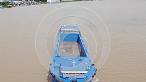 Empty barge sailing on the Mekong river