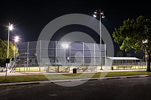 Empty baseball field with the lights on at night
