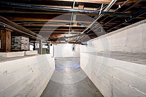 Empty basement in old house with white walls