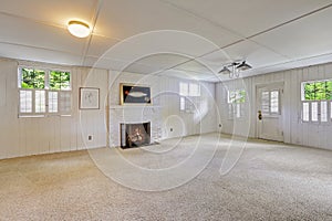 Empty basement room with fireplace