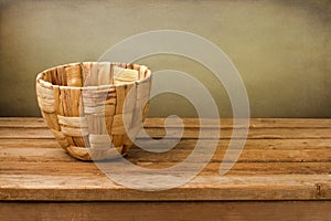 Empty basket on wooden deck table