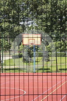 Empty basketball court outdoors on sunny day