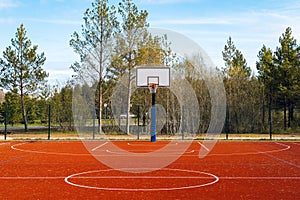 Empty basketball court on sunny day