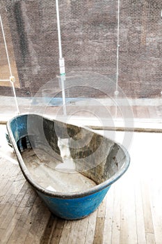 Empty bath tub in front of a window