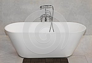 Empty bathtub with retro silver tap