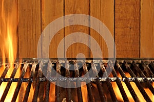 Empty BBQ Flaming Grill And Wood Wall In The Background