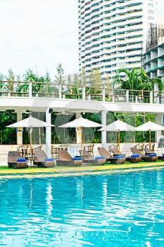 Empty beach chair around swimming pool