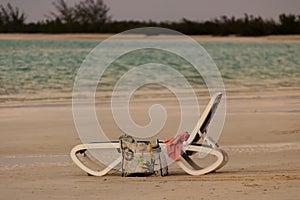 Empty beach chair on the white sandy beach