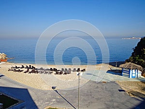 an empty beach with chairs