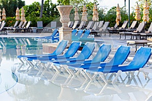 Empty beach chairs near pool