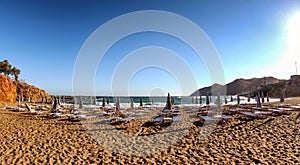 Empty beach chairs in summer resort at Panormos in Crete island, Greece