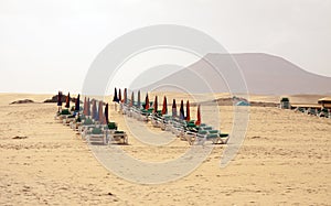 Empty beach and closed sun umbrellas. Fuerteventura, Canary, Spain